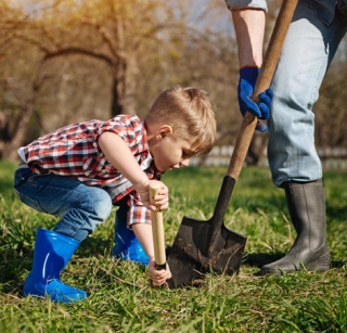 Child and adult digging with a shovel 