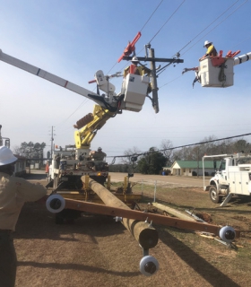 Linemen in a bucket truck working on powerlines